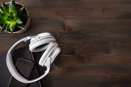 audiobook concept modern wireless headphones smartphone bookの写真素材