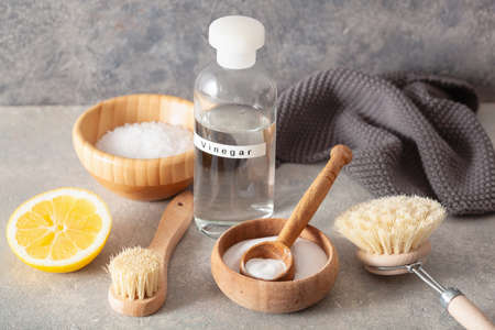 zero waste eco friendly cleaning concept. wooden brushes, lemon, baking soda, vinegarの写真素材