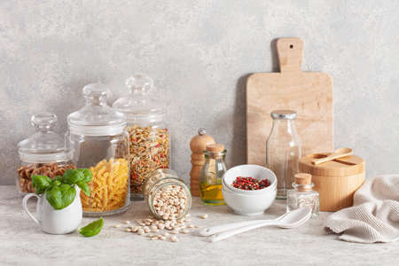 kitchen utensils on modern simple counter, kitchenware jars with dry ingredients bowlsの写真素材