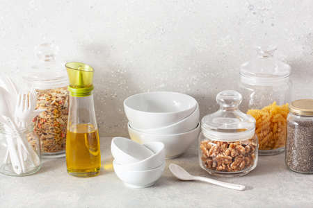 kitchen utensils on modern simple counter, kitchenware jars with dry ingredients bowlsの写真素材