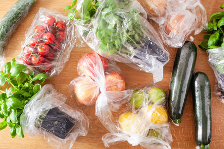 single use plastic waste issue. fruits and vegetables in plastic bagsの写真素材