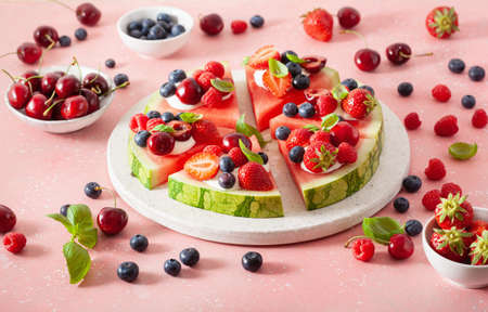 watermelon pizza slices with yogurt and berries, summer dessertの写真素材