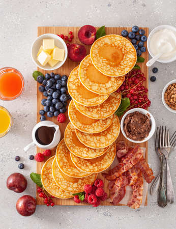 american pancake board with bacon berries maple syrup butterの写真素材