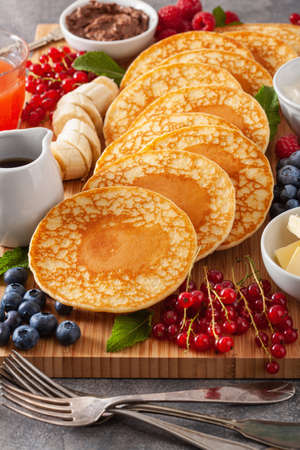 american pancake board with berries maple syrup butterの写真素材