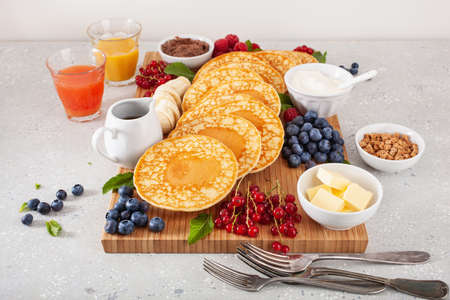 american pancake board with berries maple syrup butterの写真素材