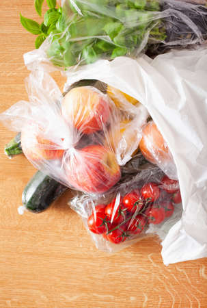 single use plastic waste issue. fruits and vegetables in plastic bagsの写真素材
