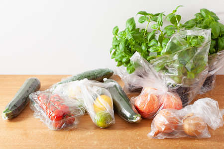single use plastic waste issue. fruits and vegetables in plastic bagsの写真素材