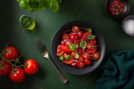 healthy tomato salad with onion basil olive oil and balsamic vinegarの写真素材