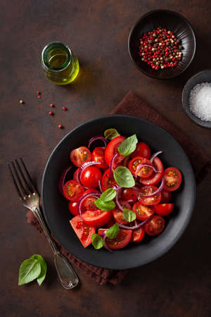 healthy tomato salad with onion basil olive oil and balsamic vinegarの写真素材
