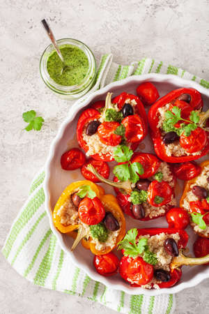 stuffed bell peppers with quinoa tomatoes olives and herb sauce chimichurriの写真素材