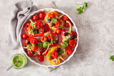 stuffed bell peppers with quinoa tomatoes olives and herb sauce chimichurriの写真素材