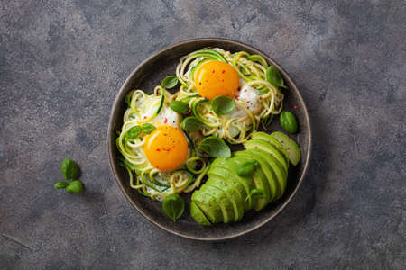 keto low carb breakfast baked spiralized zucchini with eggs and avocadoの写真素材