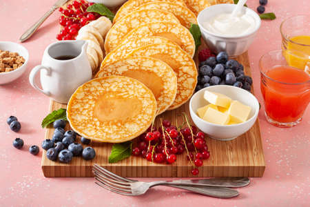american pancake board with bacon berries maple syrup butterの写真素材