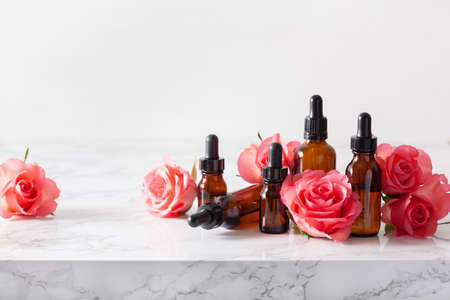 essential oils in bottles rose flowers. alternative medicine spa aromatherapyの写真素材