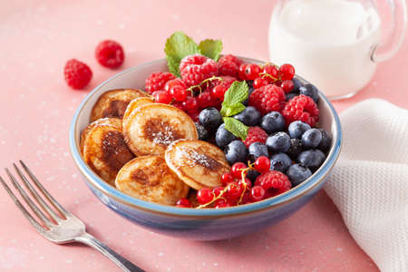 mini pancake breakfast bowl with berries and maple syrupの写真素材