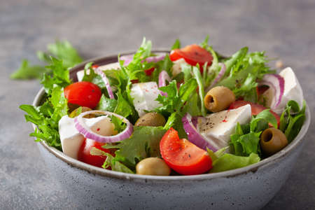 tomato salad with brie cheese olives onion lettuceの写真素材