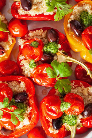 stuffed bell peppers with quinoa tomatoes olives and herb sauce chimichurriの写真素材