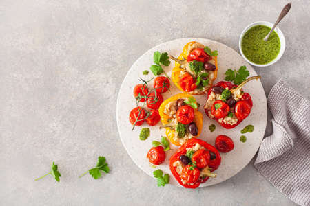 stuffed bell peppers with quinoa tomatoes olives and herb sauce chimichurriの写真素材