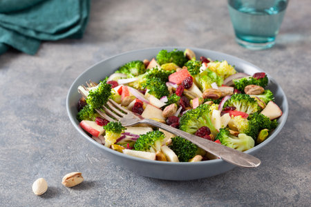 healthy broccoli salad with apple onion dried cranberries pistachio. vegan low carb dietの写真素材