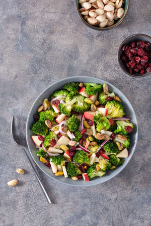 healthy broccoli salad with apple onion dried cranberries pistachio. vegan low carb dietの写真素材