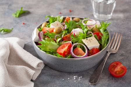 tomato salad with brie cheese olives onion lettuceの写真素材