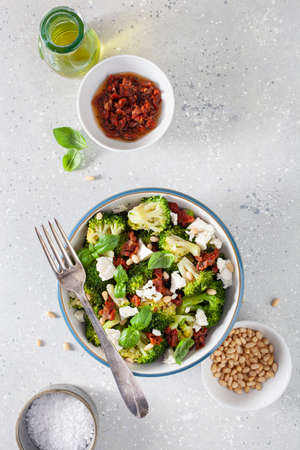 healthy broccoli salad with feta cheese sun dried tomatoes pine nuts.. vegetarian low carb keto dietの写真素材
