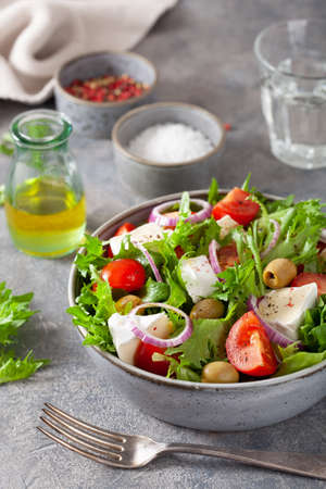 tomato salad with brie cheese olives onion lettuceの写真素材