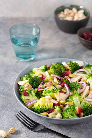 healthy broccoli salad with apple onion dried cranberries pistachio. vegan low carb dietの写真素材