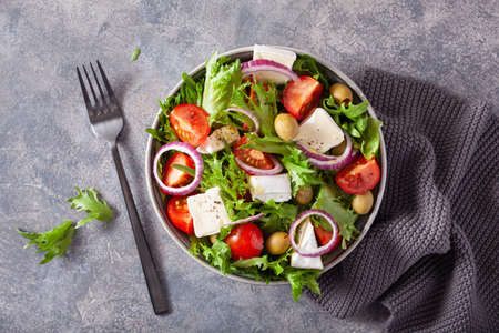 tomato salad with brie cheese olives onion lettuceの写真素材