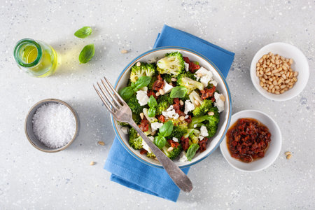 healthy broccoli salad with feta cheese sun dried tomatoes pine nuts.. vegetarian low carb keto dietの写真素材