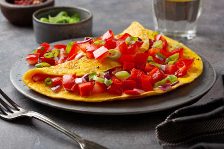 omelette with tomato, bell pepper onion chili and cheese. healthy breakfastの写真素材