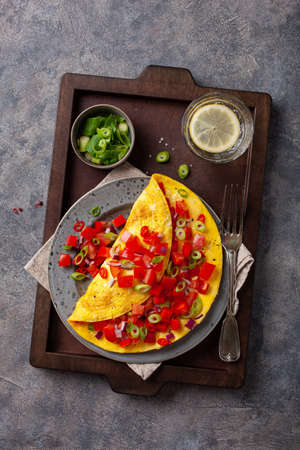 omelette with tomato, bell pepper onion chili and cheese. healthy breakfastの写真素材