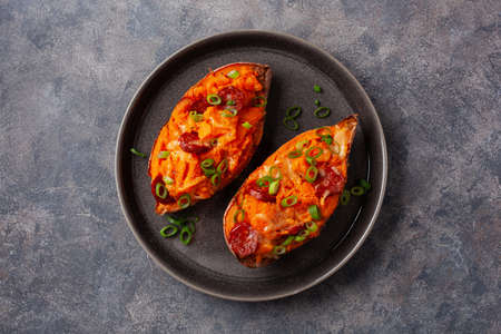 twice baked sweet potato with cheese and chorizo sausageの写真素材