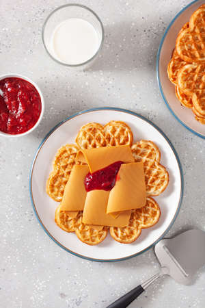waffles with Norwegian brunost traditional brown cheese and raspberry jamの写真素材