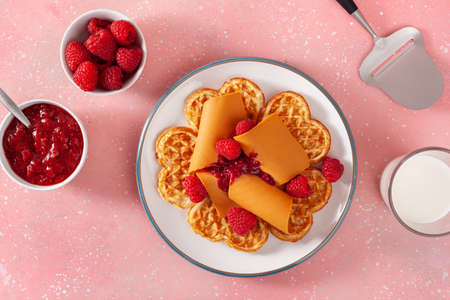 waffles with Norwegian brunost traditional brown cheese and raspberry jamの写真素材