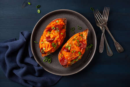 twice baked sweet potato with cheese and chorizo sausageの写真素材
