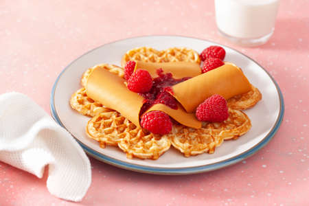 waffles with Norwegian brunost traditional brown cheese and raspberry jamの写真素材