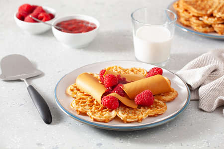 waffles with Norwegian brunost traditional brown cheese and raspberry jamの写真素材