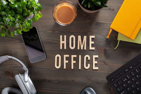home office text desk with keyboard computer smartphone notebook houseplants, workspace at homeの写真素材