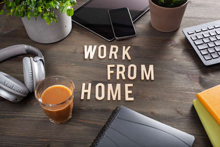 work from home text desk with keyboard computer smartphone notebook houseplants, workspace office at homeの写真素材