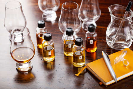 tasting bottles and glasses of whisky spirit brandy cognac. tasting at homeの写真素材