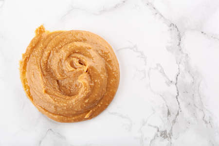 peanut butter on white marble backgroundの写真素材