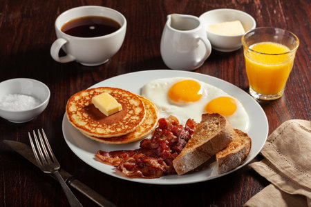 traditional full american breakfast eggs pancakes with bacon and toastの写真素材