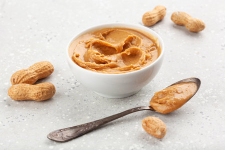 smooth peanut butter in bowl on gray backgroundの写真素材