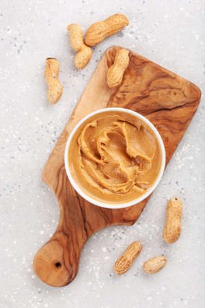 smooth peanut butter in bowl on gray backgroundの写真素材
