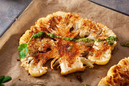 cauliflower steaks with herb sauce and spice. plant based meat substituteの写真素材