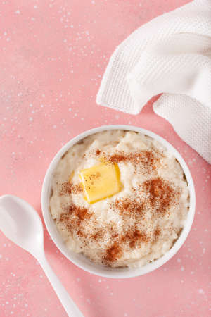 rice pudding with butter cinnamon. french riz au lait, norwegian risgrot, traditional breakfast dessertの写真素材