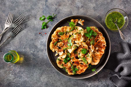 cauliflower steaks with herb sauce and spice. plant based meat substituteの写真素材