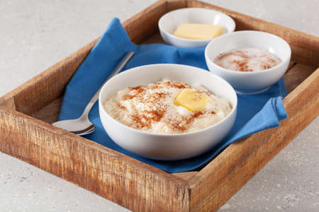 rice pudding with butter cinnamon. french riz au lait, norwegian risgrot, traditional breakfast dessertの写真素材