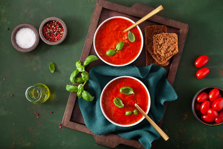 tomato and bell pepper vegetarian soup on green backgroundの写真素材